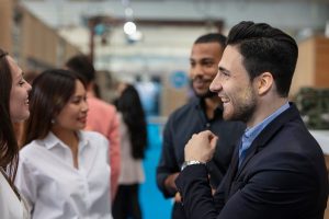 Four professionals talking with each other at a networking event